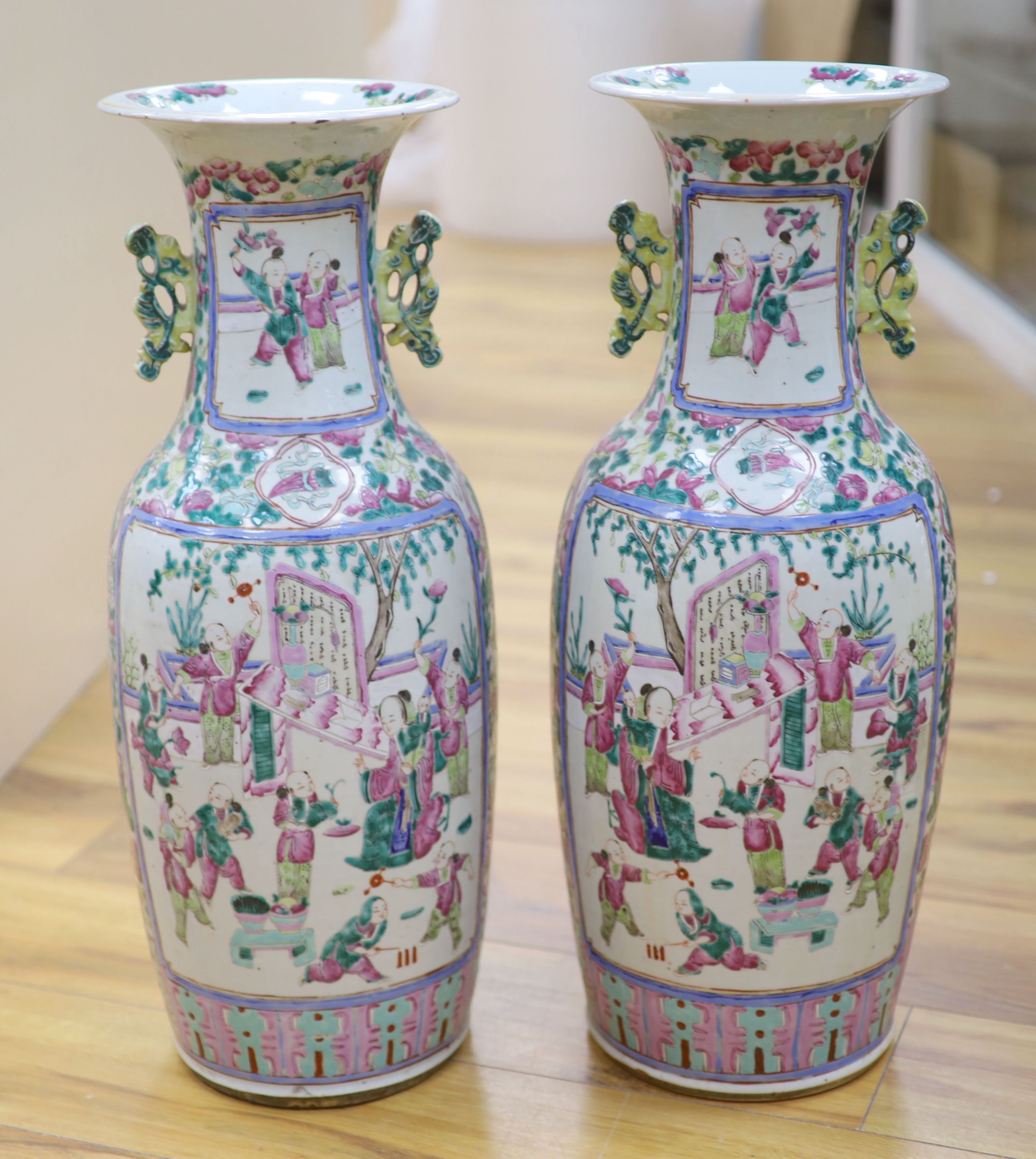 A pair of late 19th century Chinese large famille rose vases, height 61cm, one cracked